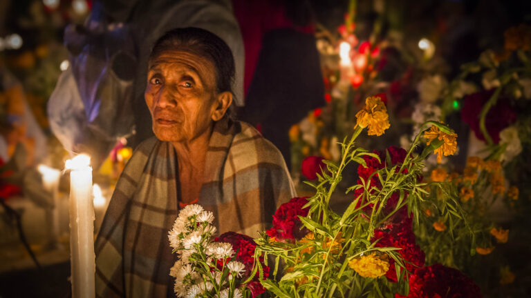 OAXACA , MEXICO - NOV 02 : Unidentified woman on a cemetery during Day of the Dead in Oaxaca, Mexico on November 02 2015. The Day of the Dead is one of the most popular holidays in Mexico