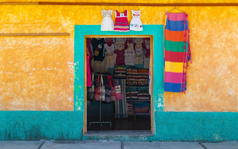 Traditional indigenous clothing shop with colorful facade in Santo Tomas Jalieza, Oaxaca state, Mexico.