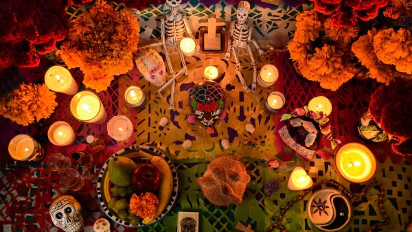 Mexican day of the dead altar at night in dim candlelight